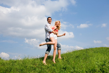 Young love couple having fun on spring meadow