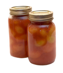 Two mason jars filled with canned tomatoes
