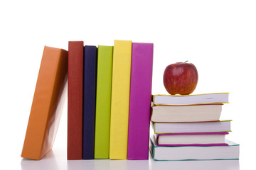 a stack of books with a apple on the top