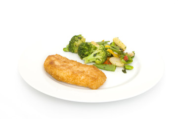 breaded piece of fish with vegetables on a plate