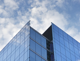 Fototapeta na wymiar tall skyscraper with cloudy blue background