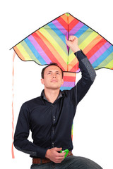 man holds kite above head