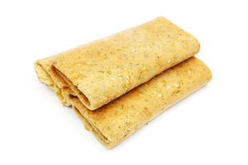 Three eggroll biscuits stacked together on white background.