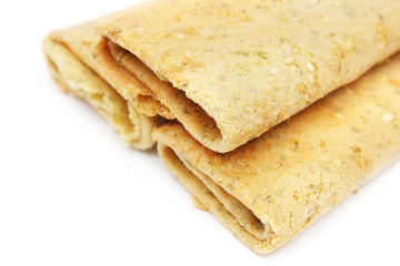 Three eggroll biscuits stacked together on white background.