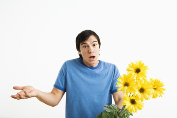 Shrugging man holding bouquet.