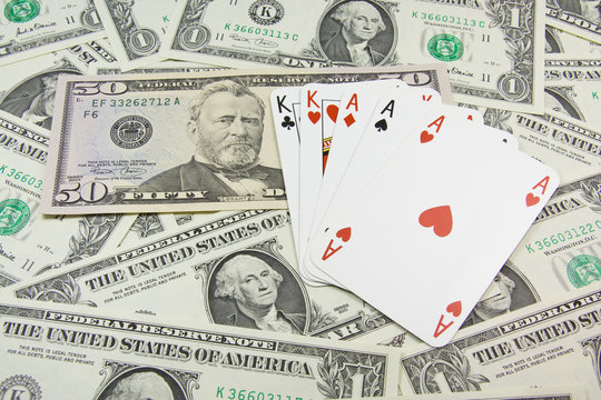 Dollar banknotes and full house holdem poker cards