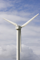 close up of wind turbine against blue sky