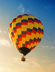 Hot air balloon soaring in early morning