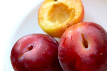 Fototapeta na wymiar closeup of three ripe plums