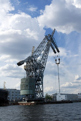 Fototapeta na wymiar Crane at cargo pier in a port