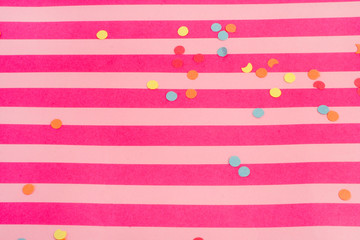 pink striped background with confetti great for parties