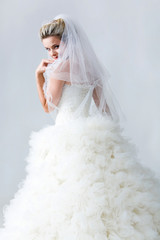 Naklejka premium Portrait of beautiful timid fiancee in white nuptial dress