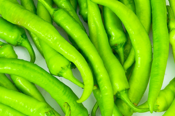 Green peppers in the  plate isolated on white