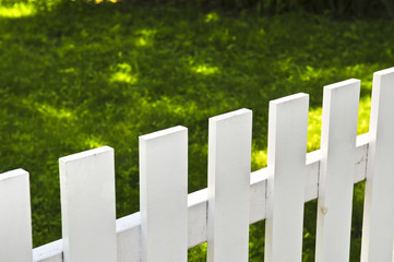 White fence around front yard of residential house