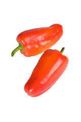 Two vibrant red gypsy peppers isolated on white