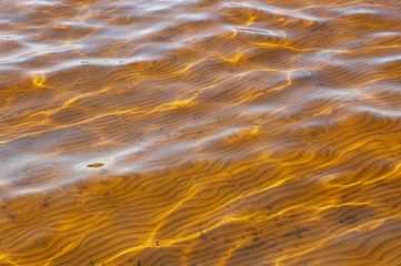 Lake. Reflections of a sun and easy waves.