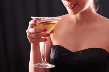 Beautiful young woman holding a martini glass