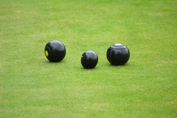 Three bowls on bowling green