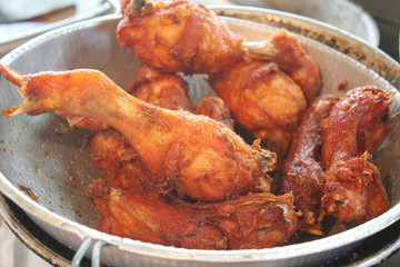 a colander full of fried chicken parts