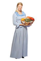 Young girl in blue dress with basketful of vegetables