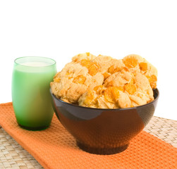 Freshly baked cookies and milk over white background