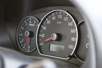 A closeup of a car dashboard with a speedometer