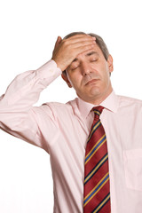 Businessman in a suit gestures with a headache