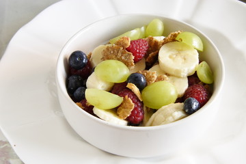 bowl of cereal with lots of  fresh fruit