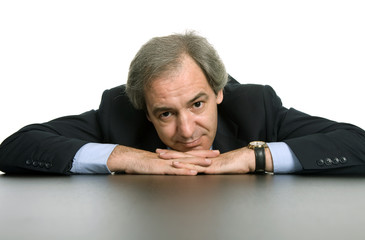 mature business man on a desk, isolated on white