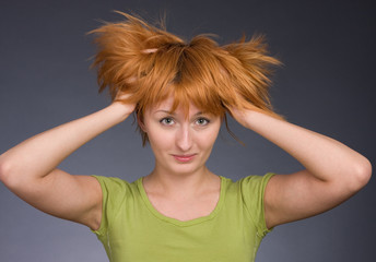 Portrait of the red-haired girl in a green T-shirt