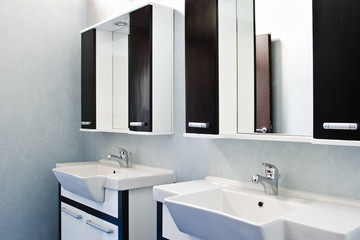 two bathroom withe sinks and mirrors