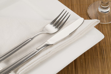 view of a single dinner setting on a bamboo placemat