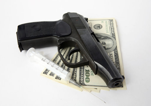 Pistol, money and syringe
