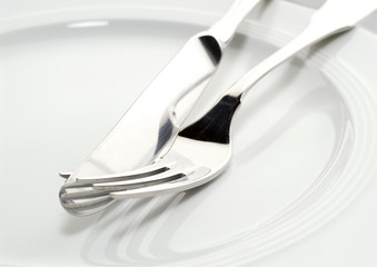 fork and knife on a plate close-up shot