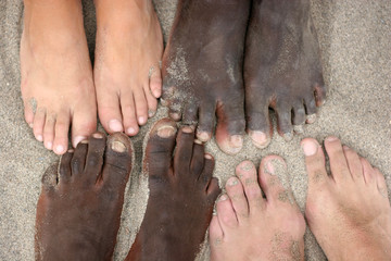 Black and white feet touch each other