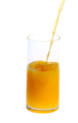 pooring orange juice in high glass on white background