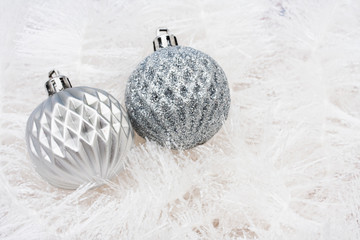 Silver glass balls on white garland background