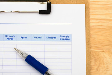 Survey attached to clipboard and pen, excellent customer service