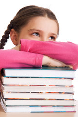 Young schoolgirl with a pile of books..