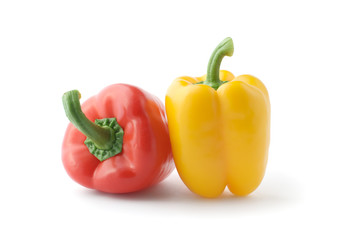 Fresh red and yellow peppers . Isolated over white
