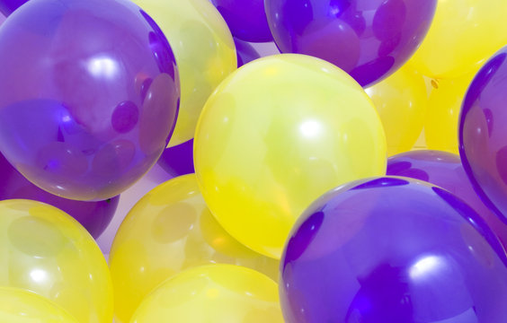 Many yellow and purple balloons background © M. Dykstra