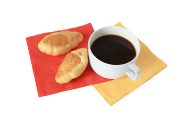 Two fresh croissants and cup of black coffee