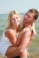 Fototapeta premium attractive couple fooling around on the beach