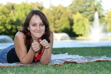 young woman relaxing near the pond, fountain