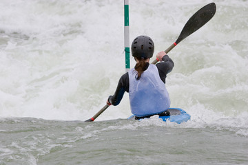A canoeist paddling through fast running white water