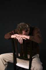 Obraz premium man in chair with head down