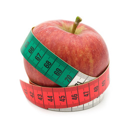 red apple in measuring tape on white background