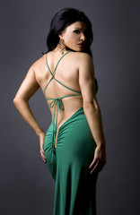 pretty glamour model wearing green dress in studio