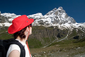 Woman in red hat looking on Matterhorn peak