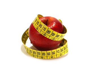 Red apple and tape measure isolared on white